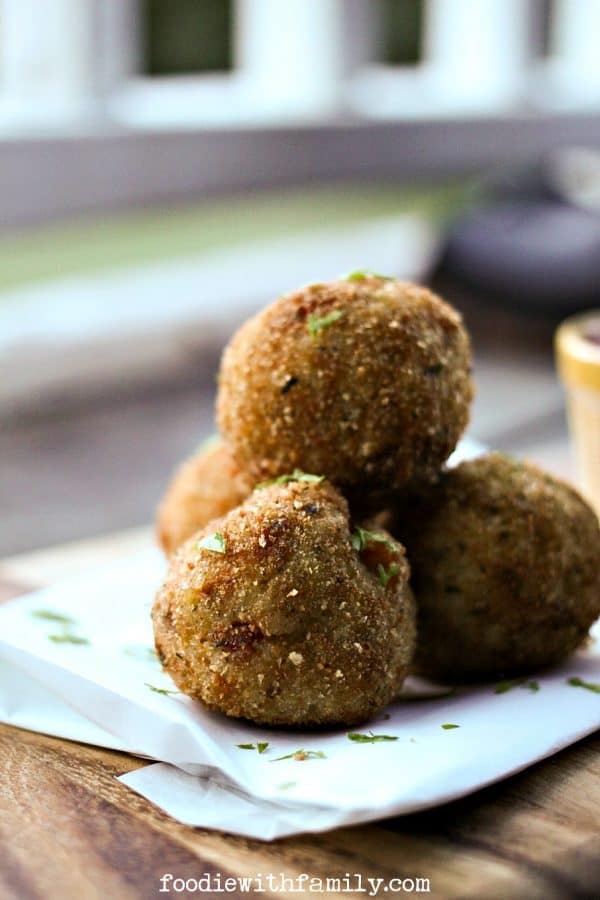 Prosciutto Arancini {crispy cheese-stuffed, fried risotto balls} from foodiewithfamily.com