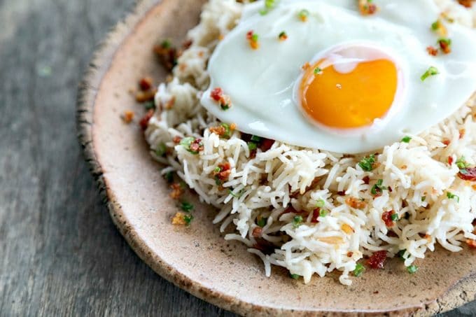 Bacon Garlic Rice; tender grains of basmati rice bursting with bacon, fried garlic, and fresh green onion. It's a flavour explosion that is great with grilled chicken, fish, beef, or pork, or nibbled straight from the fridge at midnight.