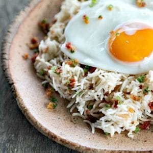 Bacon Garlic Rice; tender grains of basmati rice bursting with bacon, fried garlic, and fresh green onion. It's a flavour explosion that is great with grilled chicken, fish, beef, or pork, or nibbled straight from the fridge at midnight.