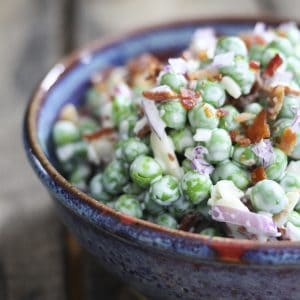 Easy Bacon Pea Salad: It doesn't get much easier or tastier than this cold salad of peas, crispy bacon, crunchy red onions, and creamy dressing. Serve with grilled or roasted chicken, pork, fish, or even ham!