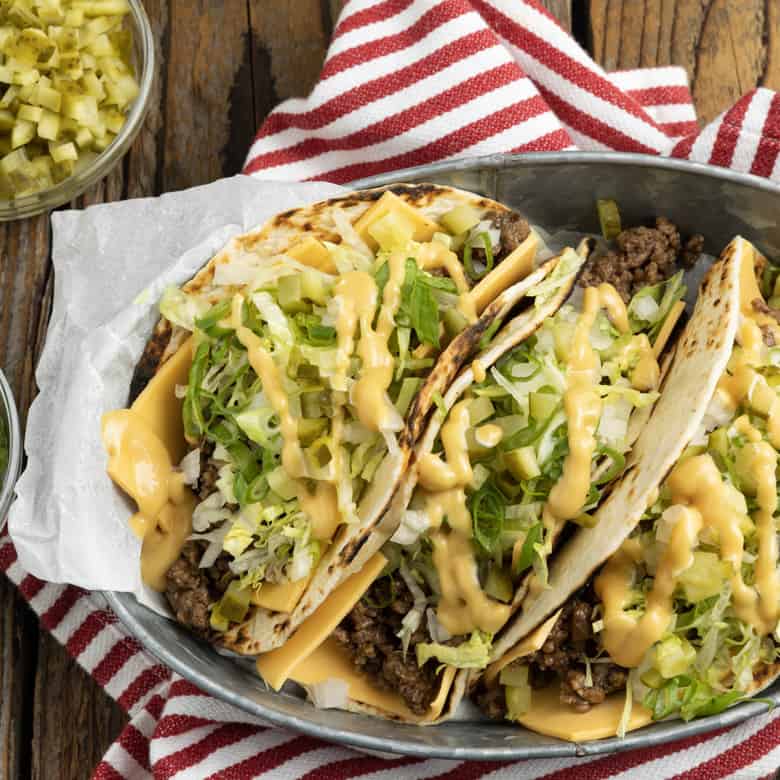 Big Mac Tacos: bringing “the golden arches” to taco night with irresistible tacos filled with seasoned beef, special sauce, lettuce, cheese, pickles, and onions on a sesame seed… tortilla. It’s everything you love about Big Macs in taco form and you don’t even have to leave the house to indulge!