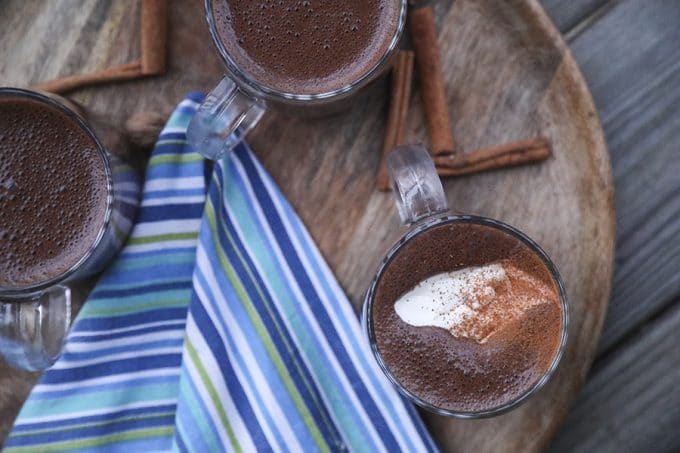 Creamy, rich, blender made spiced hot chocolate is made with just two main ingredients: good chocolate and milk. It has just a hint of warming cinnamon, nutmeg, and cayenne and is as easy as the powdered packets but worlds better. 