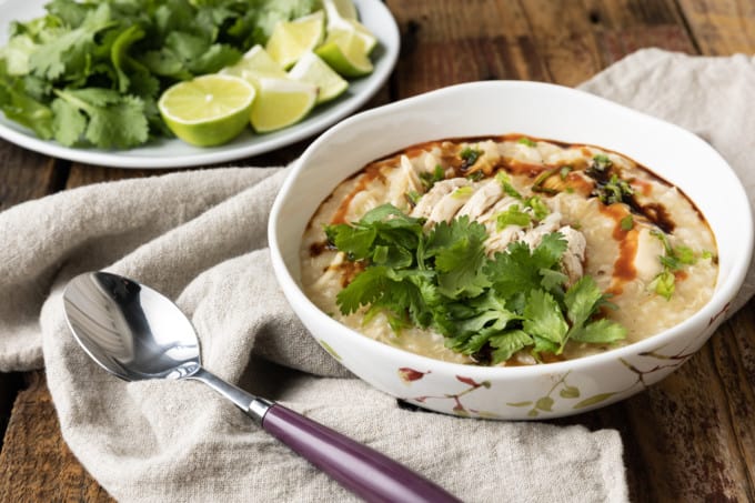 Chao Ga is a savoury, silky, thick, comforting, and filling Vietnamese chicken and rice soup or porridge that is as easy to make as it is budget friendly! Whether you serve this chicken congee for breakfast, lunch, or dinner, you’re going to love the fresh, vibrant Vietnamese flavours in this fast, fabulous, delicious dish. For an aromatic dish that bursts with flavour, this recipe is shockingly easy to prepare. And while it will undoubtedly fill you up, it’ll do so for pennies and won’t leave you feeling weighed down.