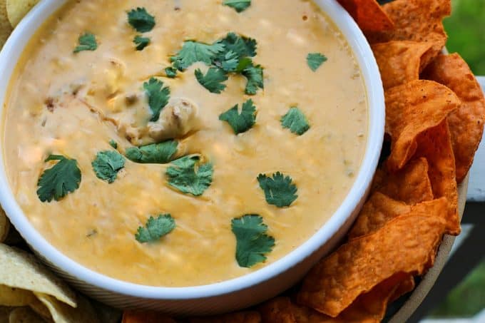 Ooey-gooey, chile studded heavenly queso smothers your favourite chili for a bowl of the ultimate Chili Con Queso Dip. Get those chips ready to go!