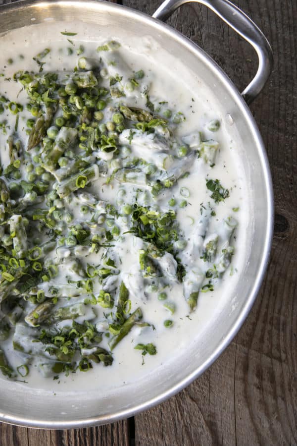 Tender spring peas and asparagus combine in a garden herb cream sauce in this new-fashioned take on delightfully old-fashioned Creamed Peas. Served over toast, this is one simple, economical dish wows!