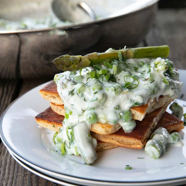 Tender spring peas and asparagus combine in a garden herb cream sauce in this new-fashioned take on delightfully old-fashioned Creamed Peas. Served over toast, this is one simple, economical dish wows!