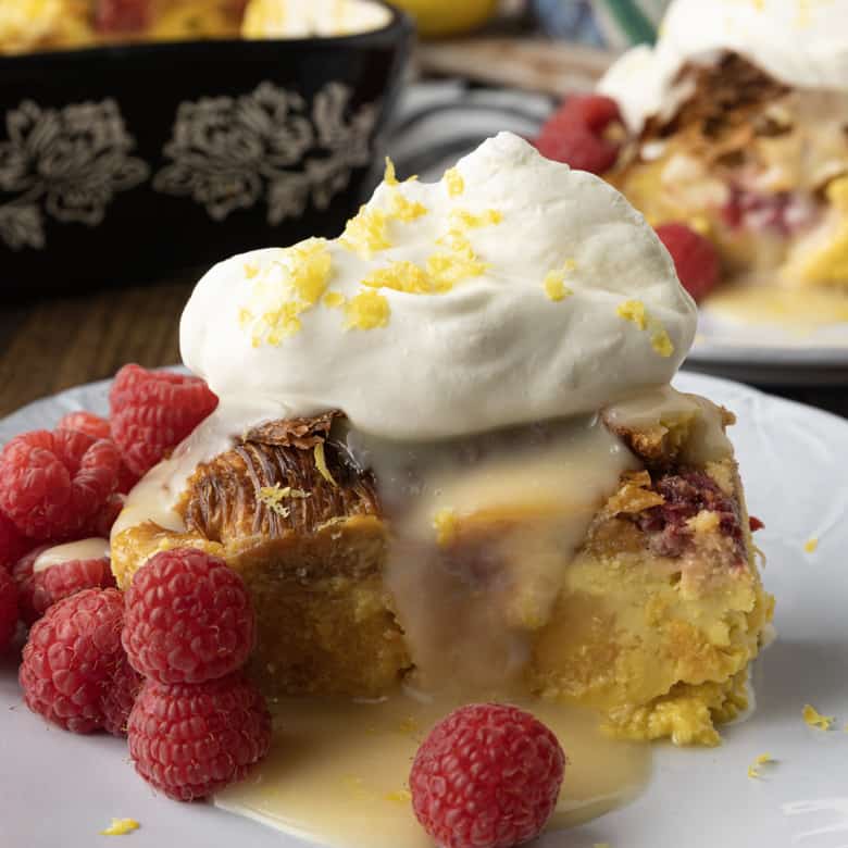 Rich, buttery, & indulgent, this creamy lemon and raspberry croissant bread pudding recipe is almost unbelievably easy to make. The flaky, layered croissant top gives way to the silky, vanilla and lemon scented custard that is studded with fresh raspberries. Optional cream cheese dotted through the custard makes this extraordinary decadent bread pudding taste a little like a cheesecake. It takes so few minutes of hands-on time to make any breakfast, brunch, or dessert a memorable occasion.