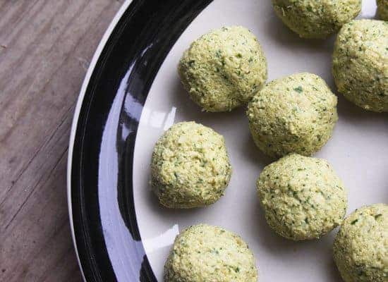 falafel balls before frying on a black and white plate