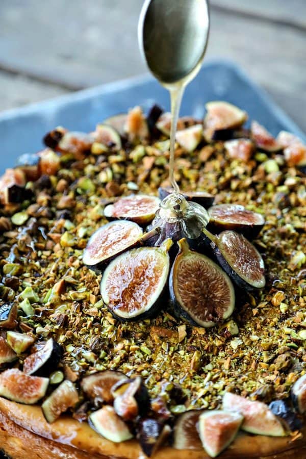 Ultra-creamy, not too sweet, and a feast-for-the-eyes while still being simple to make, this vanilla bean flecked Fig Pistachio Honey Goat Cheese Cheesecake is a show stopper!