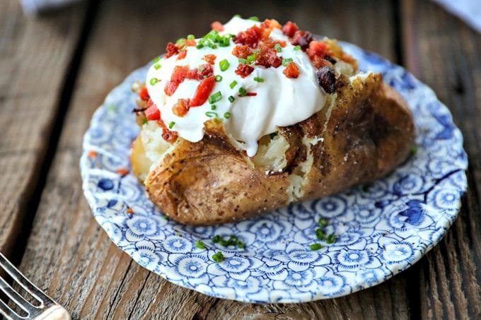 The Best Baked Potato is a thing of beauty. Our method best way to bake a potato yields a crisp, salty skin with fluffy insides every single time and is absolutely fool proof.