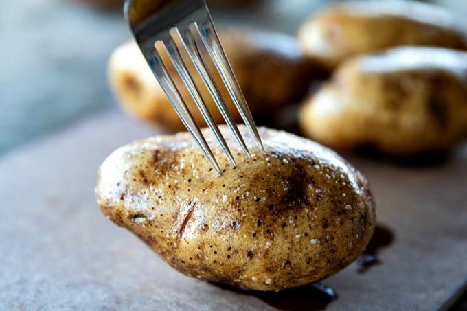 The Best Baked Potato is a thing of beauty. Our method best way to bake a potato yields a crisp, salty skin with fluffy insides every single time and is absolutely fool proof.