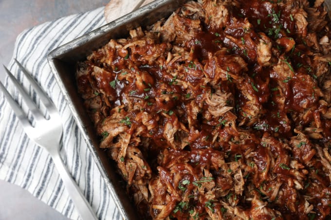 Today’s slow cooker recipe for Jack Daniels Pulled Pork is my go-to; it’s a reliable, easy recipe for the best pulled pork ever. Budget-friendly succulent pork shoulder slow cooks in Jack Daniels forming an irresistible whiskey bbq sauce. I mean honestly. How could this be anything less than sublime?