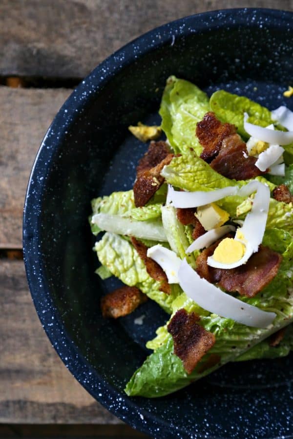 Jerk Bacon Caesar Salad waiting to be dressed with Thick Caesar Dressing.