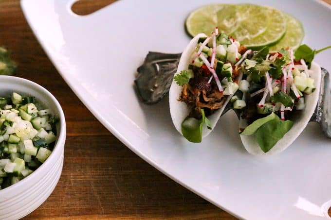 Jicama Tacos with carnitas, cucumber onion salsa, radishes, and cilantro.