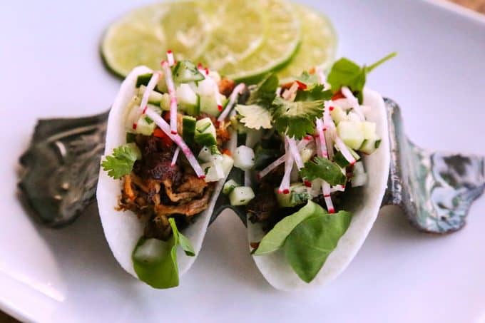 Jicama Tacos with carnitas, cucumber onion salsa, radishes, and cilantro.