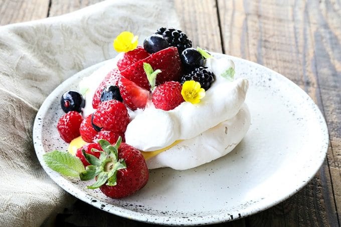 Ethereally light, crisp on the outside, marshmallowy on the inside, this Mini Pavlova Recipe is foolproof and ready for summer!