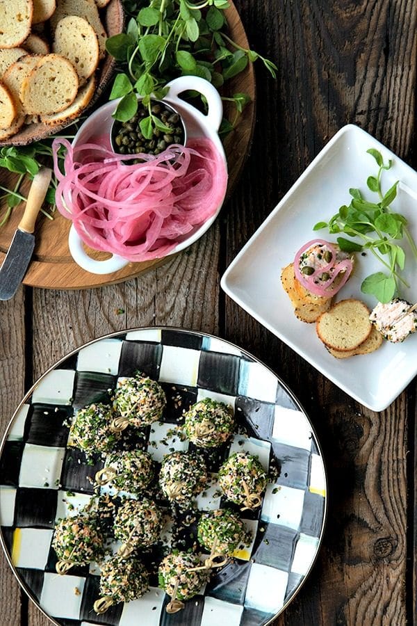 These gorgeous little two-bite, miniature cheese balls are dressed up with smoked salmon, chives, and everything bagel seasoning and taste like New York City when served with bagel chips, pickled red onions, and capers.