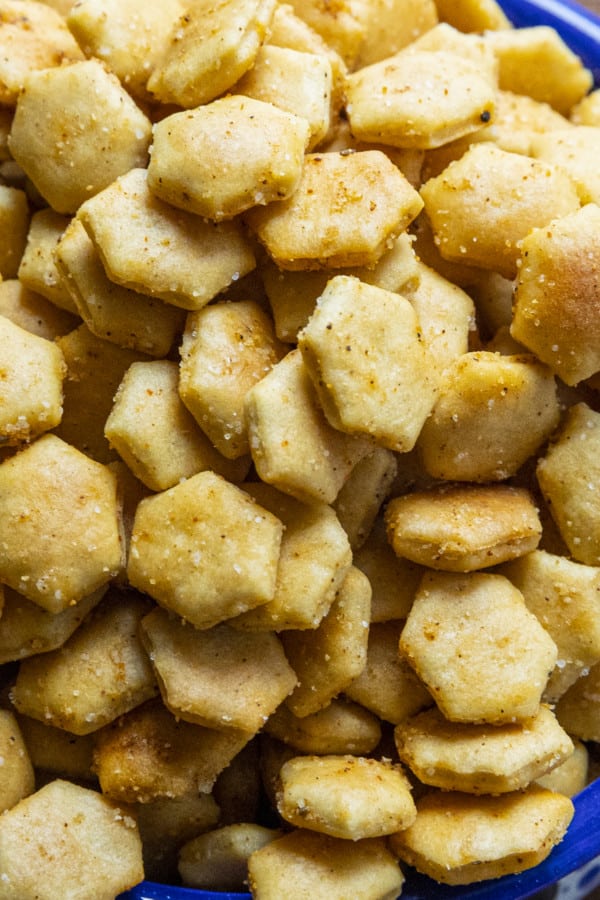 Old Bay Seasoned Oyster Crackers in a blue and white bowl with a canister of Old Bay Seasoning.