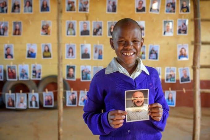 A Child looking at potential sponsors to choose through World Vision's Chosen program.