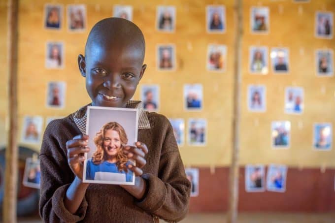 A Child looking at potential sponsors to choose through World Vision's Chosen program.