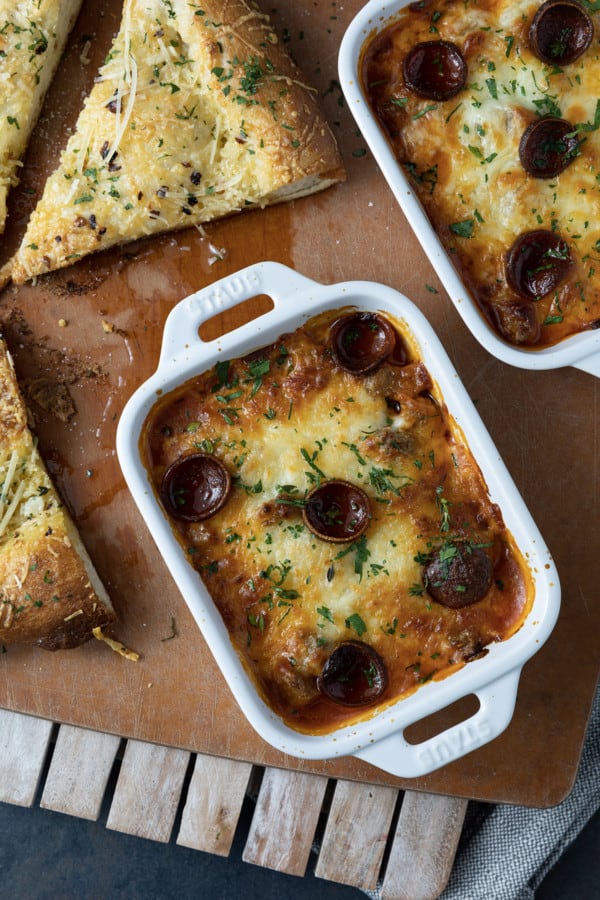 There’s no easier, more comforting dinner on the fly than this easy pizza bowl recipe! Garlicky marinara sauce, mozzarella cheese, pepperoni, succulent Italian sausage, and whatever else you love as pizza toppings are baked in individual servings until the cheese is bubbling and melted and the pepperoni is crispy at the edges.