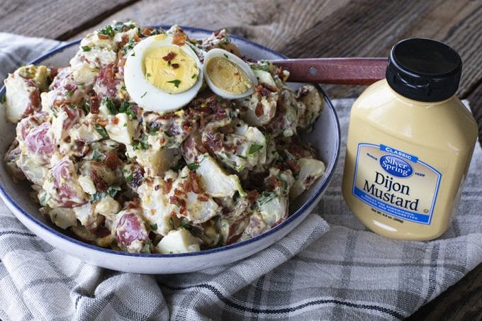 This next level potato salad has a full pound of crispy bacon, a creamy dressing with a hint of Dijon mustard, fresh herbs, hard boiled eggs, and tender potatoes. It's sure to be your new favourite potato salad for grilling and picnic season.