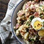 This next level potato salad has a full pound of crispy bacon, a creamy dressing with a hint of Dijon mustard, fresh herbs, hard boiled eggs, and tender potatoes. It's sure to be your new favourite potato salad for grilling and picnic season.