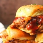 Easy Pulled Pork Sliders: Pillowy rolls filled with delicious, mouth-watering, tender pulled pork, bbq sauce, and cheese are brushed with melted butter, garlic, and herbs, then baked to toasty, melty perfection. They’re like the little black dress of the sandwich world and perfect for every occasion. Bonus: They're done in 30 minutes from start to finish!