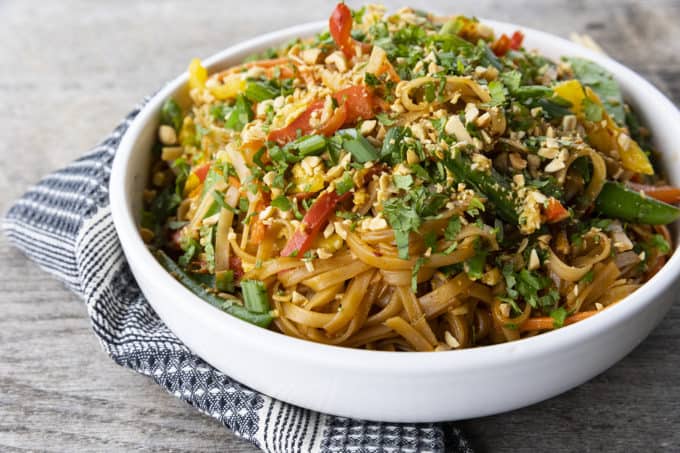 Chewy rice noodles scandalously loaded with crisp tender vegetables, a flavourful garlic and ginger sauce, and eggs make up our divine Rice Noodle Stir Fry.