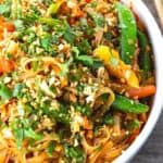 Chewy rice noodles scandalously loaded with crisp tender vegetables, a flavourful garlic and ginger sauce, and eggs make up our divine Rice Noodle Stir Fry.