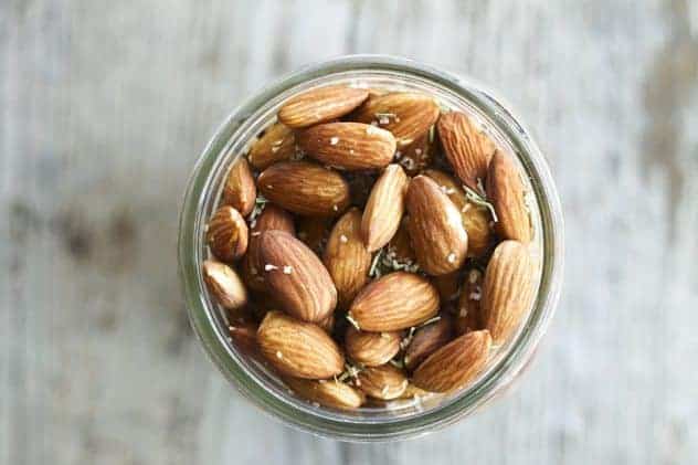 These fragrant and toasty rosemary garlic almonds slow-roast in an ultra low oven overnight (so as not to destroy all those good fats that almonds contain) while you sleep. When you wake, you are in possession of one ultimately sustaining and habit forming snack. Make yourself nuts today! In a good way!