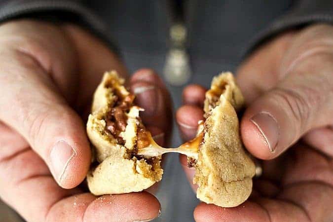 Gooey, Snickers Stuffed Peanut Butter Cookies #cookies foodiewithfamily.com