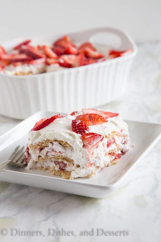 Strawberry Ice Box Cake - no bake cake that is perfect for summer. Layers of fresh whipped cream, strawberries, and graham crackers. It will disappear quickly!