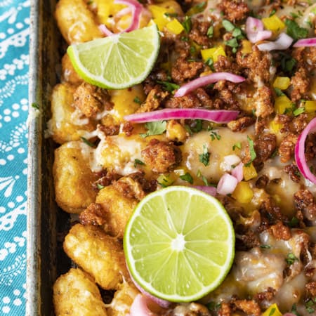 Change up Nacho Night by serving crave-ably good Tater Tot Nachos a.k.a. Totchos. These irresistible crispy baked tots are topped with spicy Chorizo, gooey melted Cheddar, pickled onions, and other nacho goodies!