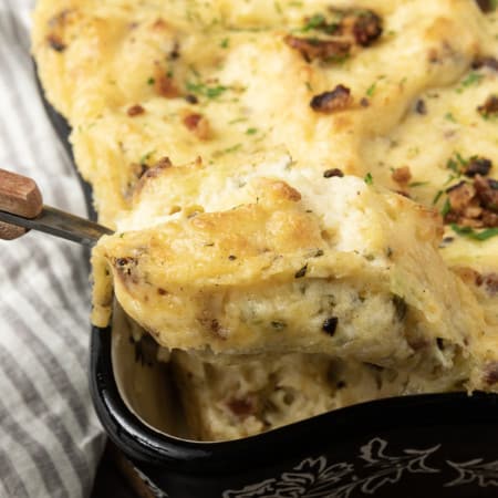 Get ready to dig into a baking dish filled with piping hot, irresistibly golden crusted, super creamy Twice Baked Mashed Potatoes. This make-ahead perfect side dish combines everything you love about creamy mashed potatoes, baked and twice baked potatoes; grated cheese, sour cream, crispy bacon, fresh herbs, and a whisper thin crispy crust at the edges. The only thing better than the taste of Twice Baked Mashed Potatoes casserole is its convenience. You can make it up to three days ahead of time and reheat before serving or you can make it, wrap it tightly, and freeze it for up to a month.